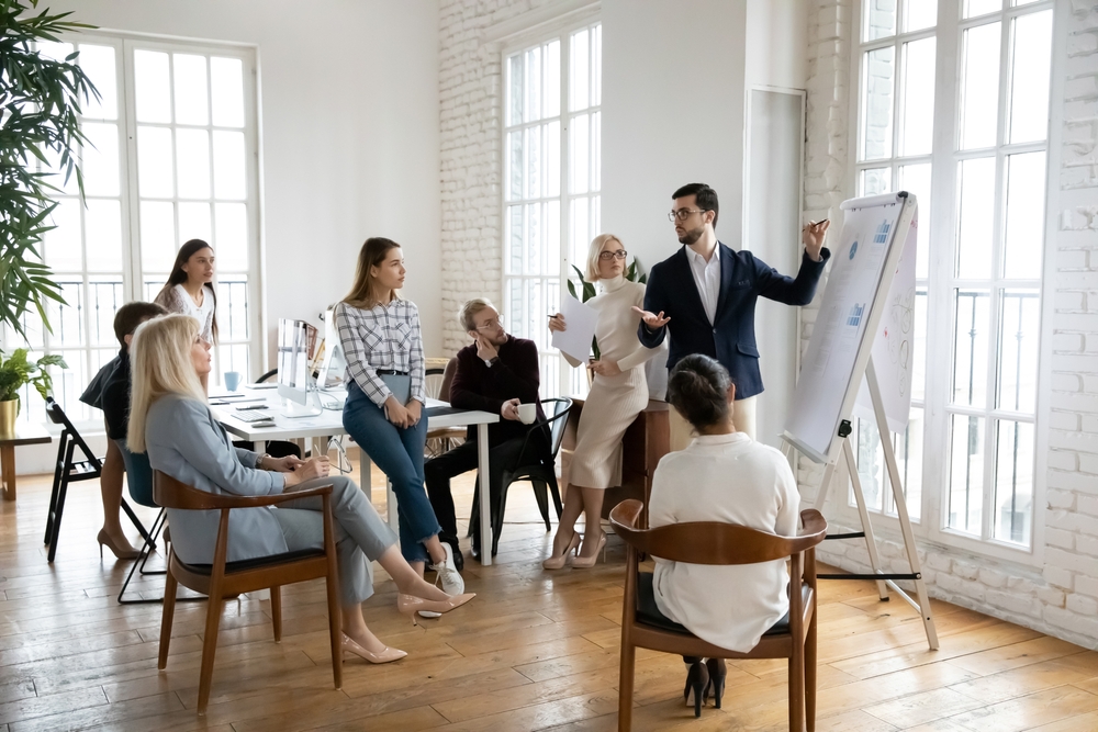 Confident,Male,Boss,Or,Trainer,Make,Whiteboard,Presentation,For,Diverse